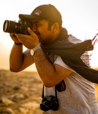 Younes Mohammad Conflict photographer Younes Mohammad looking through camera